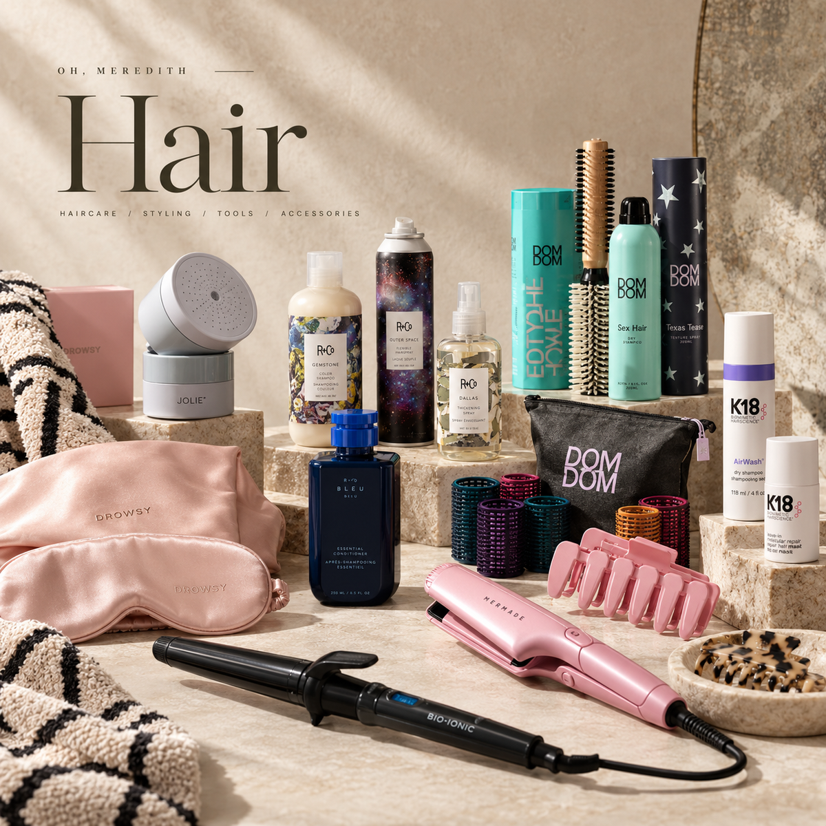Editorial flat lay of luxury hair products and styling tools for the Oh, Meredith Hair Collection.