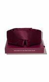 Maroon satin sleep mask on a matching box with 'GOGOYLY' branding and text.