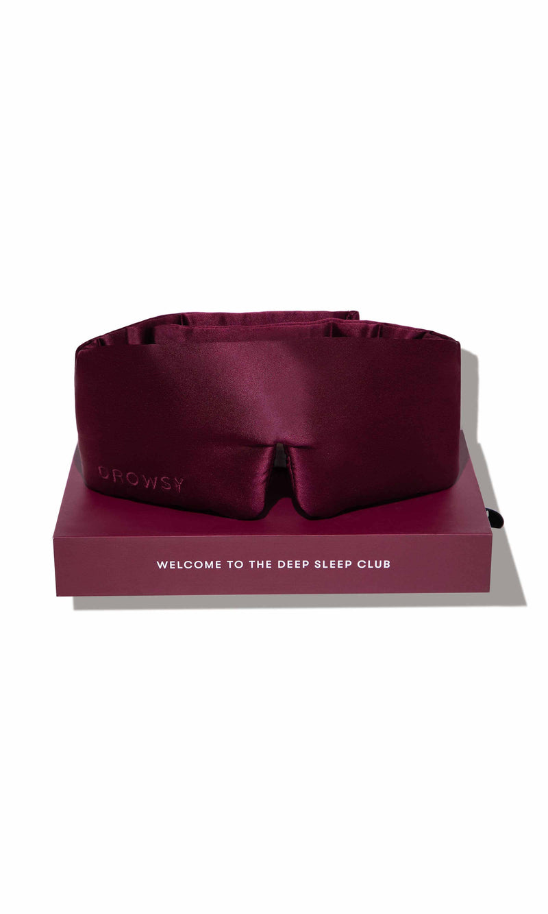 Maroon satin sleep mask on a matching box with 'GOGOYLY' branding and text.