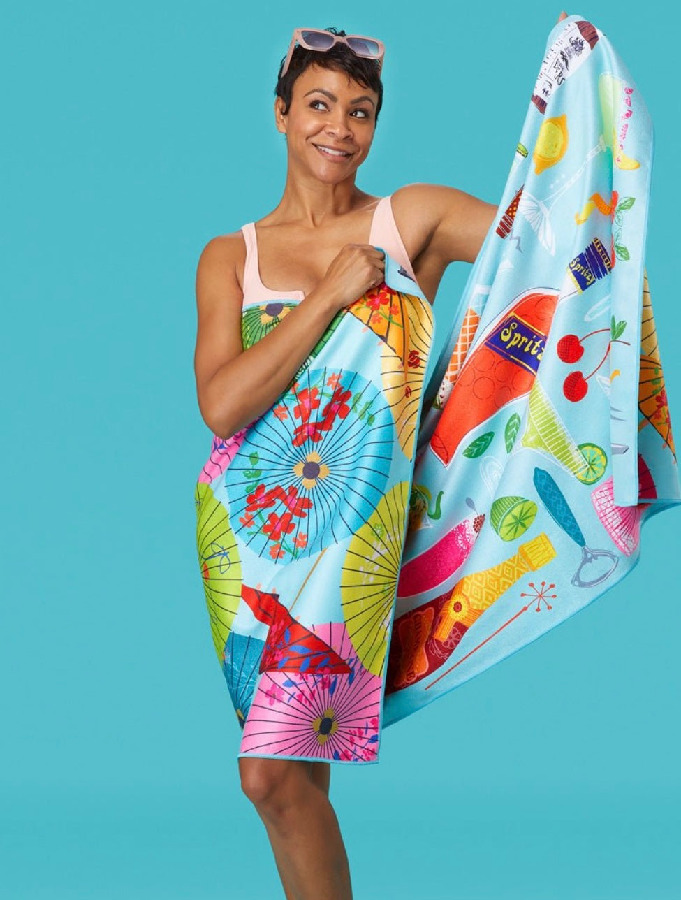 Woman holding a colorful towel with various patterns against a blue background