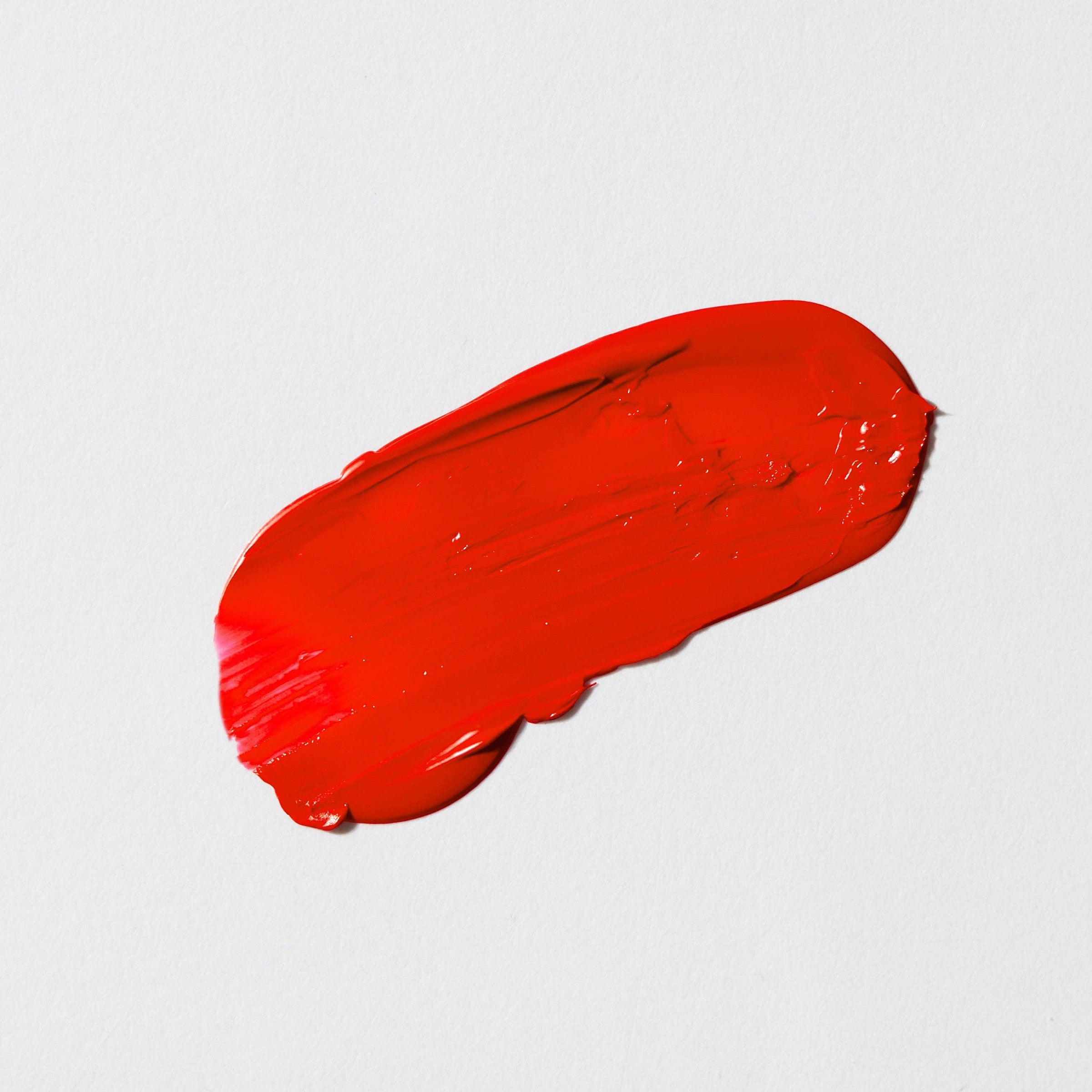 A Salute in Red vibrant blue-based red lipstick swatch with creamy semi-matte finish