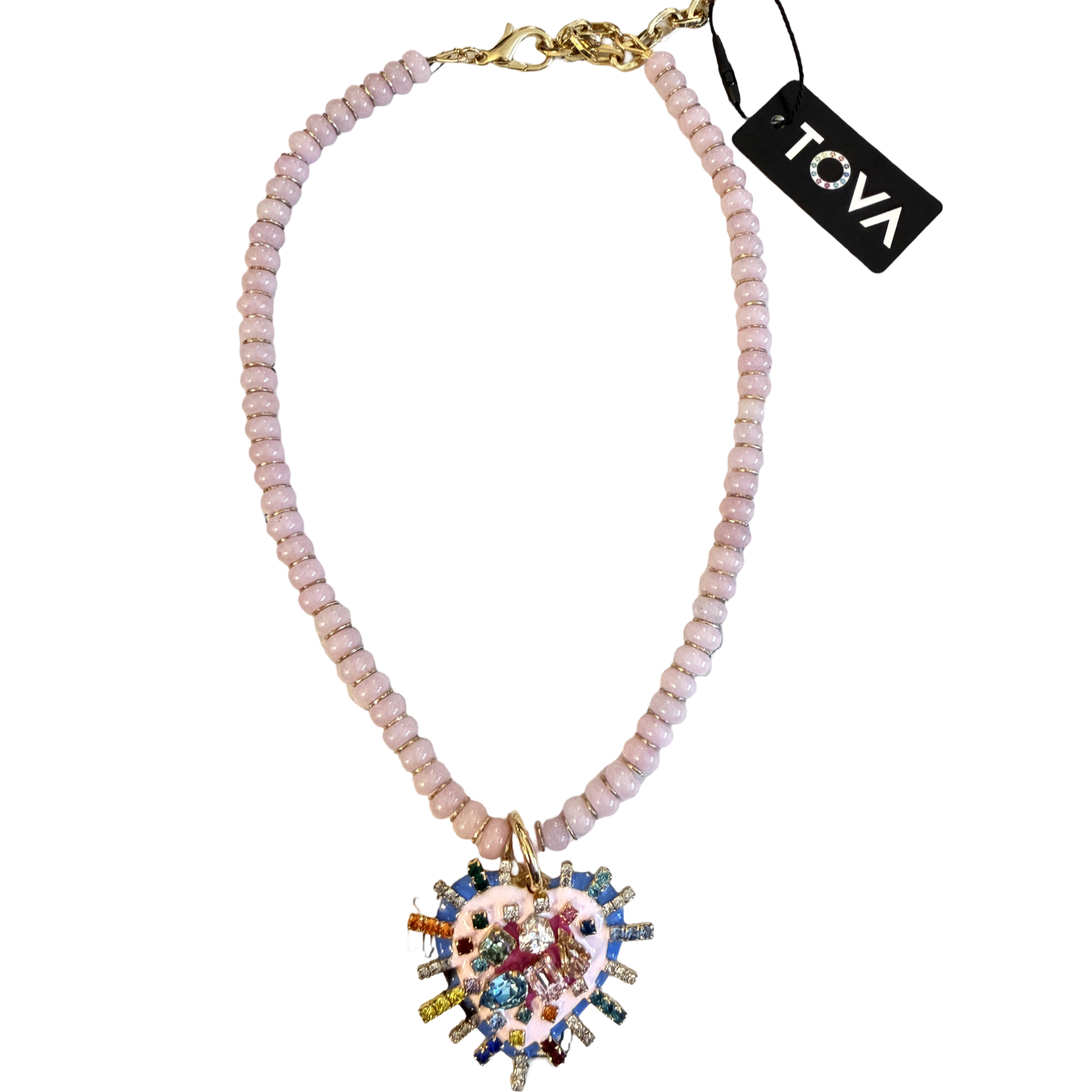 A Tova brand beaded necklace featuring light pink faceted beads, a gold-tone clasp, and a large, colorful heart-shaped pendant with cartoon-style illustrations and rhinestones.