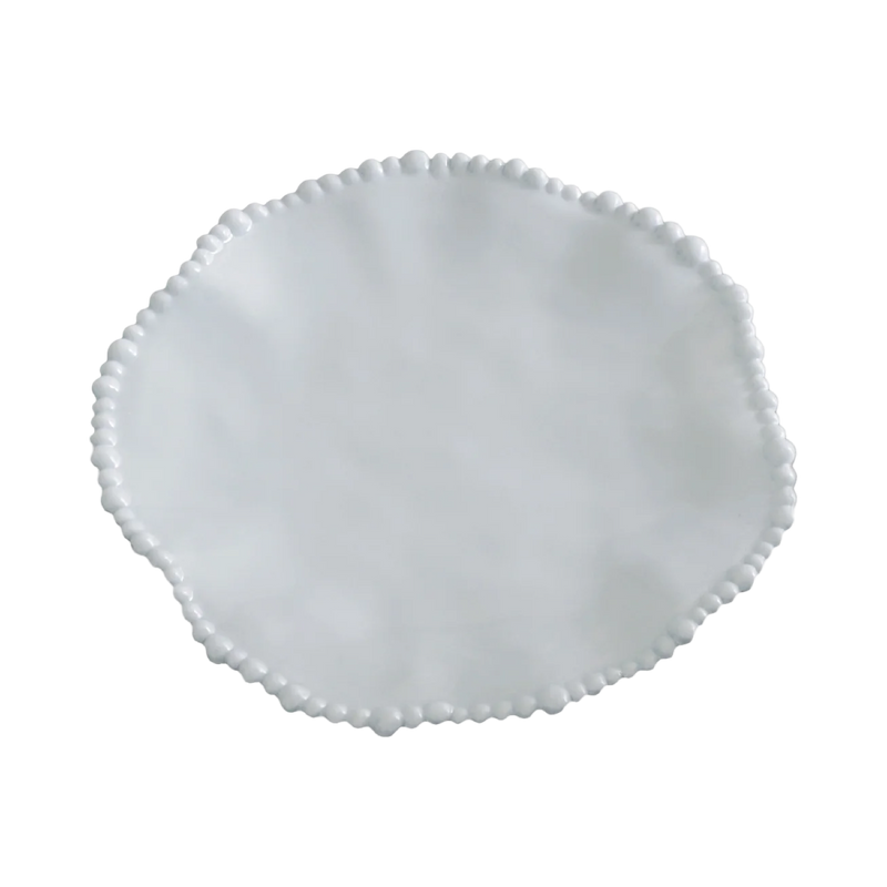 White ceramic plate with decorative rim on a white background