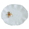 White decorative plate with small colorful flowers on a white background