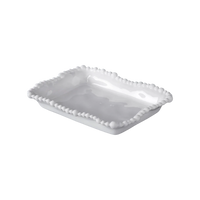 White ceramic serving dish with decorative edge on a white background