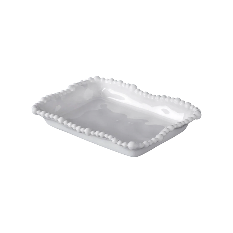 White ceramic serving dish with decorative edge on a white background