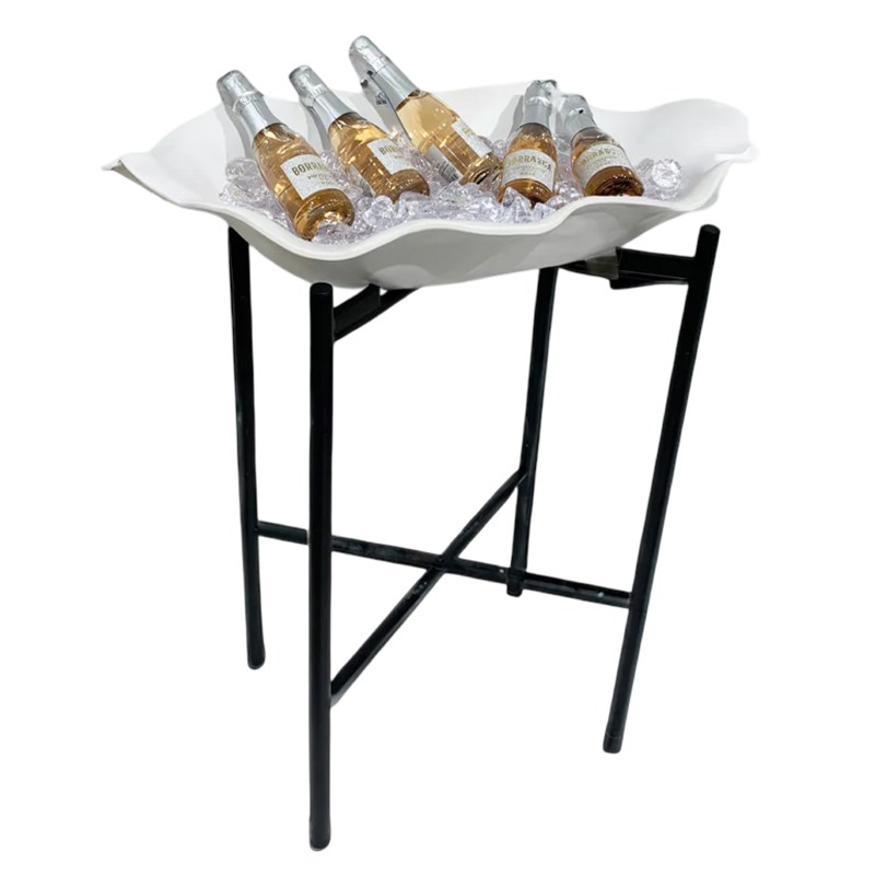 White shell-shaped tray with bottles on a black stand against a white background