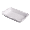 White ceramic dish with decorative edge on a white background