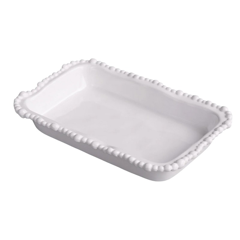 White ceramic dish with decorative edge on a white background
