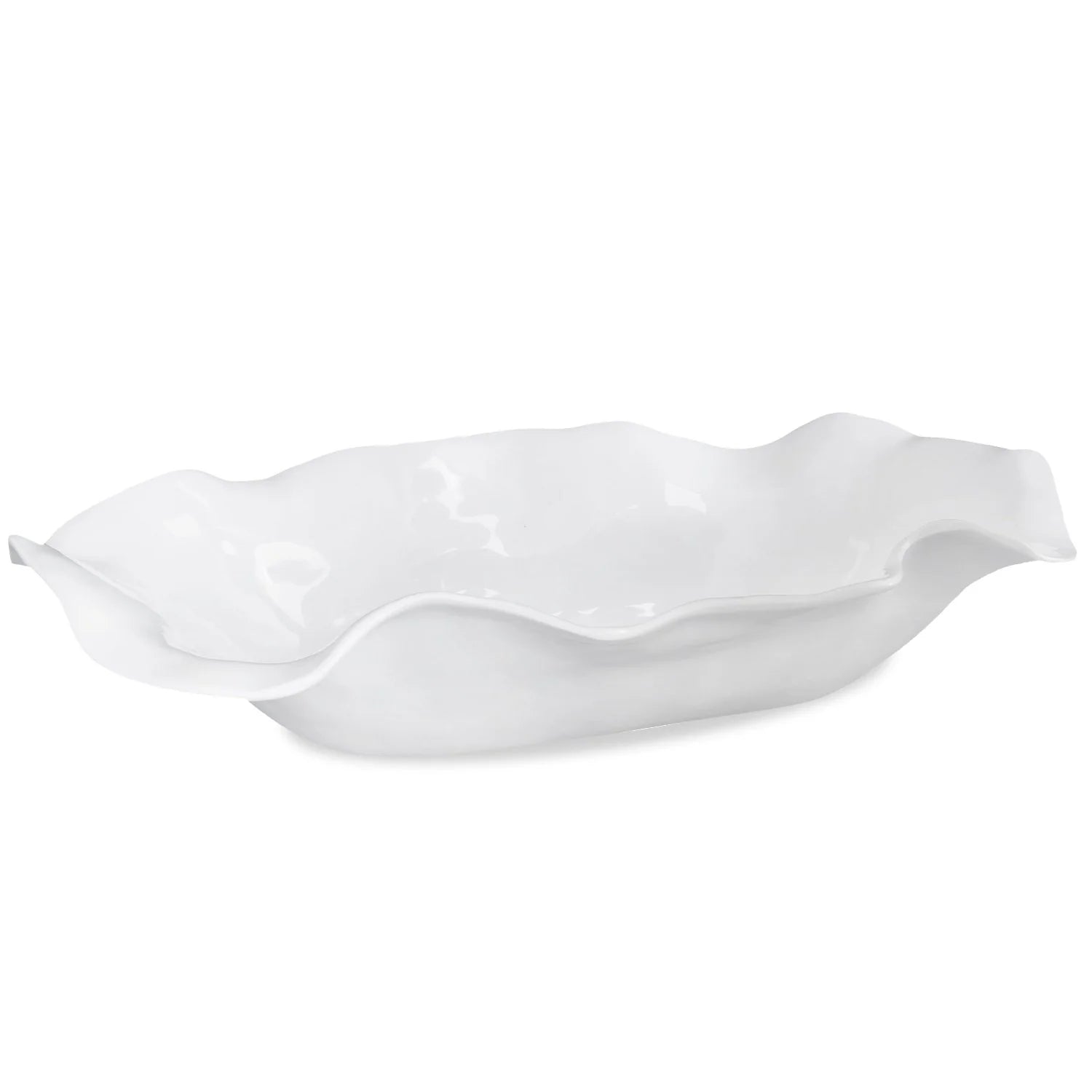 White ceramic serving dish with wavy edge on a white background