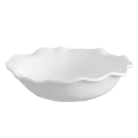 White ceramic bowl with scalloped edge on a white background