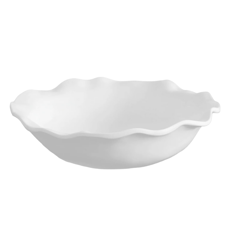 White ceramic bowl with scalloped edge on a white background