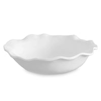 White ceramic serving bowl with wavy edge on a white background