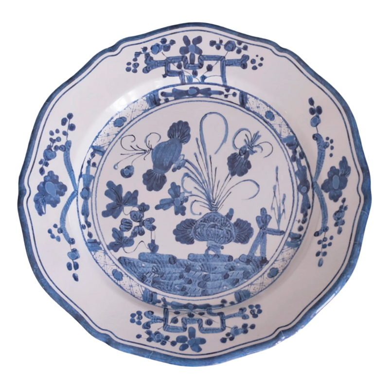 Decorative plate with blue floral and botanical design on a white background