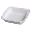 White ceramic dish with decorative edge on a white background
