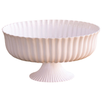 Decorative bowl with ribbed design on a white background