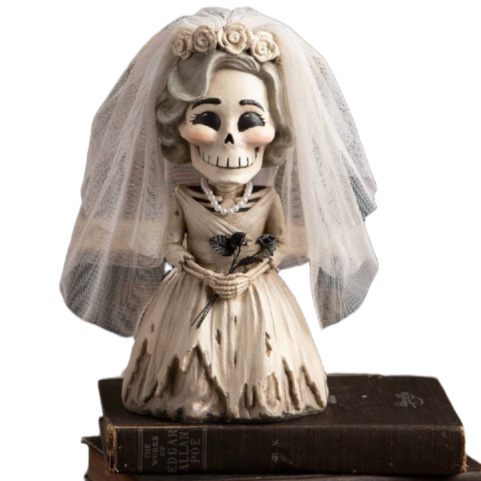 A bride skeleton figurine wearing a tattered wedding dress, veil, and floral crown, posed on top of vintage books against a plain white background.