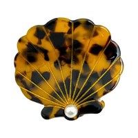 Brown tortoise seashell acetate hair claw clip with pearl-inspired center accent.