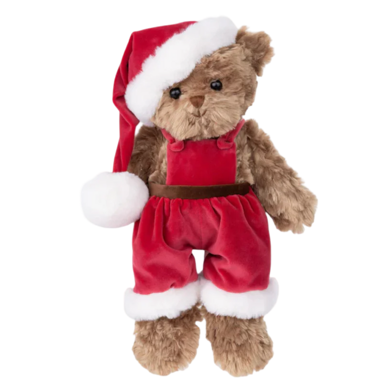 Plush teddy bear dressed in a Santa outfit with red jumpsuit and hat on a white background