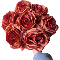 Burnt orange and deep red vintage-style faux rose bouquet with seven full rose stems and leaves