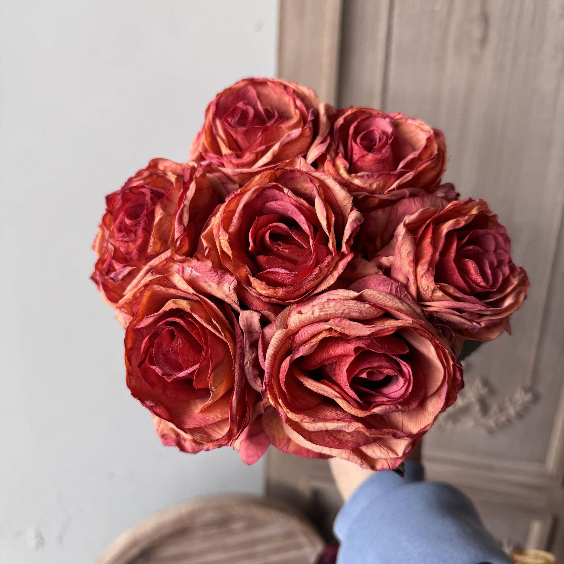 Burnt orange and deep red vintage-style faux rose bouquet with seven full rose stems and leaves