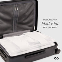 Black suitcase with white packing cubes inside, designed to fold flat for packing.