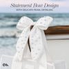 White bow with pearl detailing on a boat against a blurred ocean background