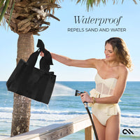 Woman at the beach holding a black bag and a water sprayer, with text about the bag's waterproof properties.