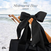 Black statement bow on a chair with a beach background