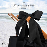 Black statement bow on a chair with a beach background