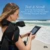 Woman using a touchscreen pouch on the beach with text overlay.