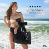 Woman in black and white bikini holding a black tote bag on a beach with text 'Five-Stars For A Reason'.