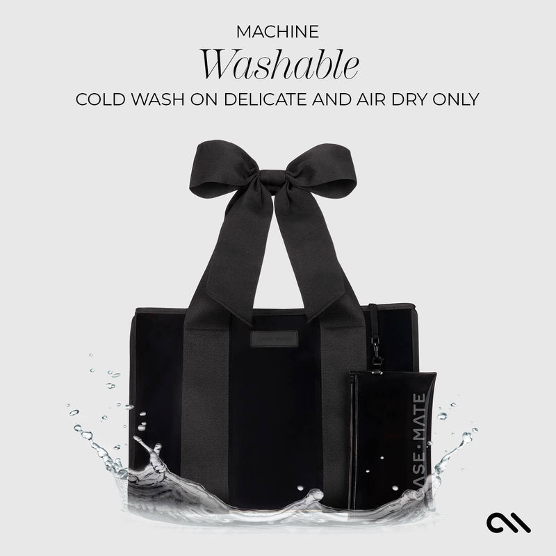 Black tote bag with a bow on a white background, featuring washing instructions.