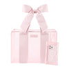 Pink tote bag with a bow and phone case on a white background
