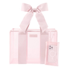 Pink tote bag with a bow and a phone case on a white background