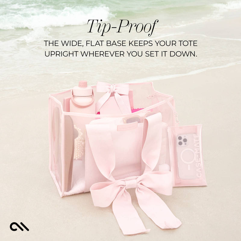 Pink tote bag with accessories on a light background, featuring text about the tote's stability.
