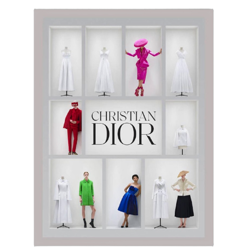 Display case with mannequins wearing Christian Dior clothing on a white background