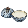 Decorative candle with a blue and white patterned holder on a white background