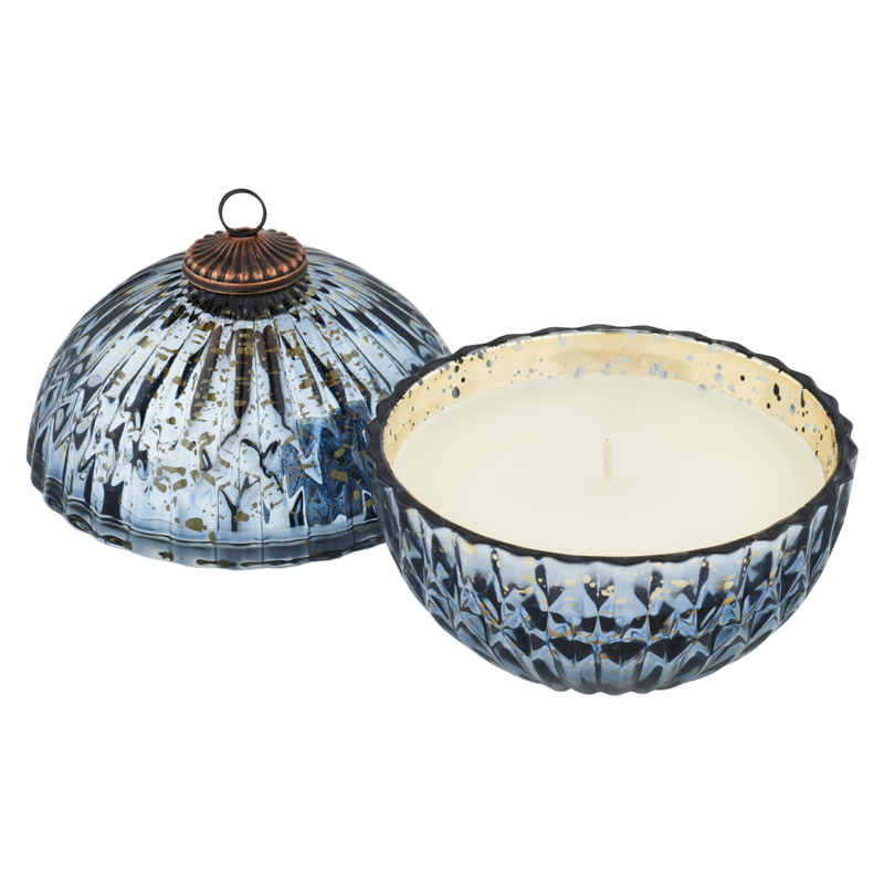 Decorative candle with a blue and white patterned holder on a white background