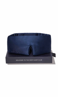 Navy blue sleep mask on a black stand with 'UHOO' branding and text on a white background