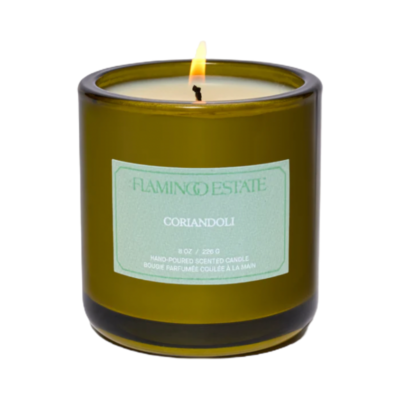 Green candle with a label on a white background