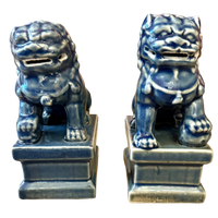 Two blue ceramic lion statues on white background