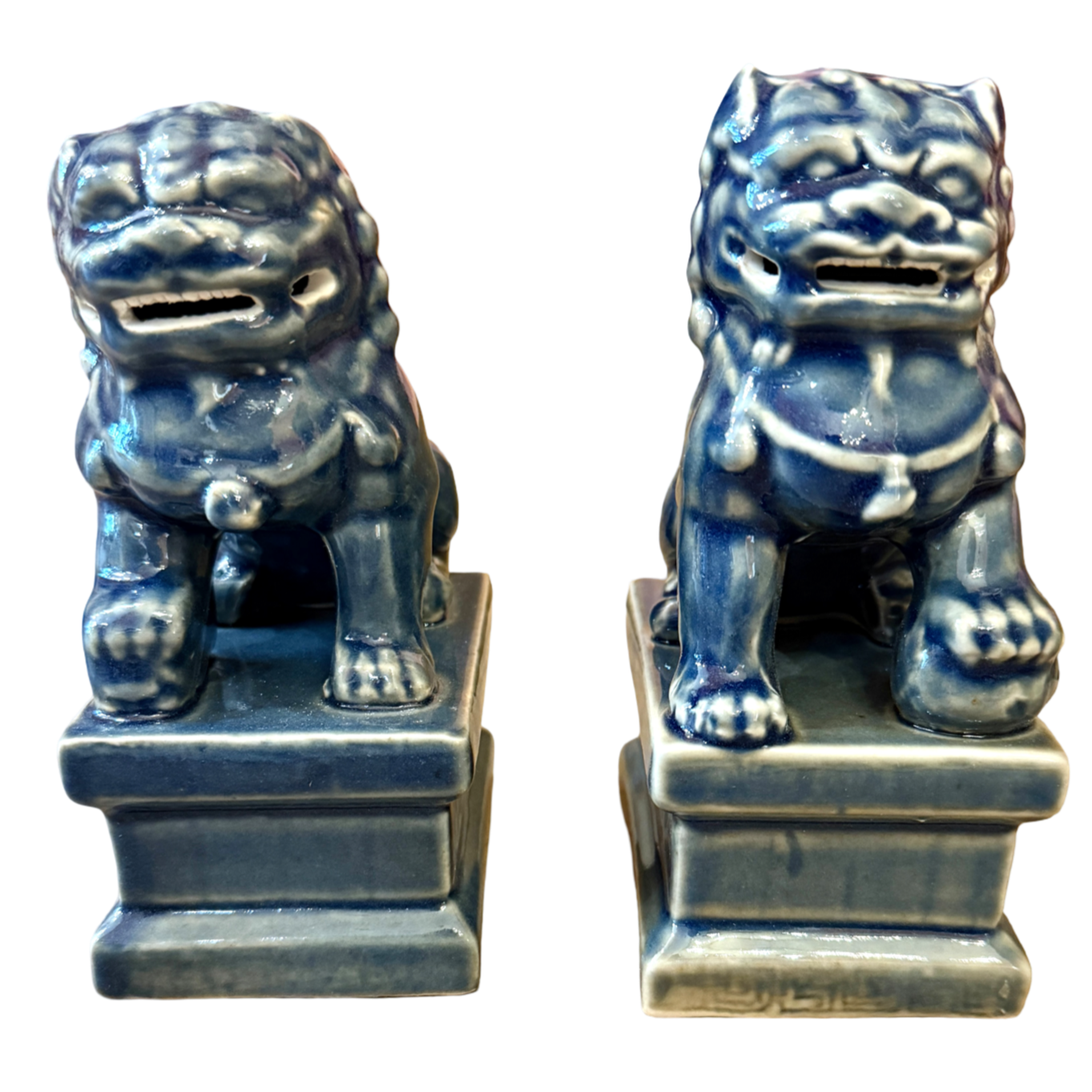 Two blue ceramic lion statues on white background