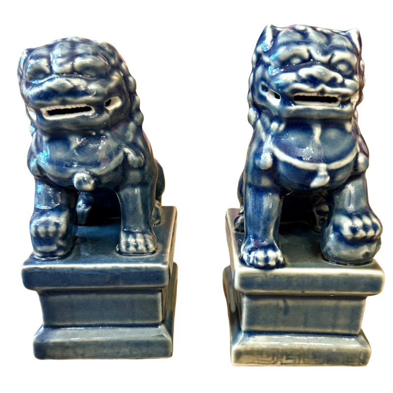 Two blue ceramic lion statues on white background