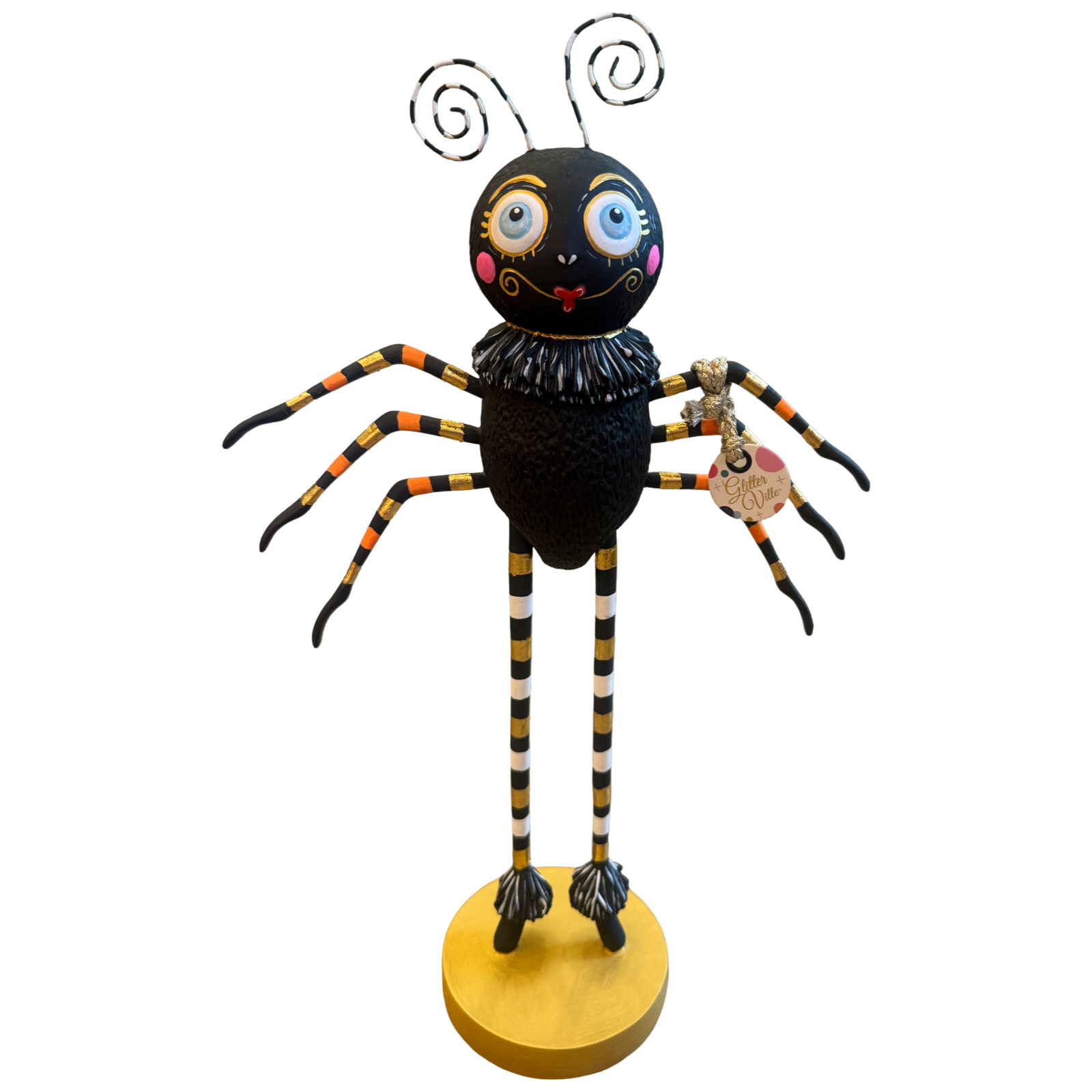 Glitterville Spinderella black spider Halloween figure with oversized blue eyes, striped legs, ruffled collar, gold accents, and round gold base.