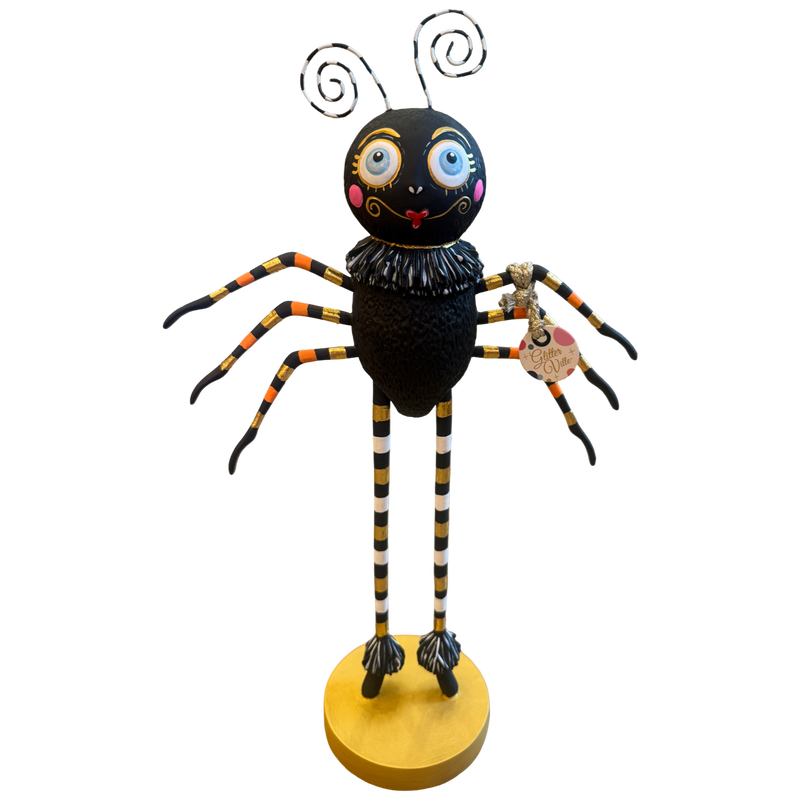 Glitterville Spinderella black spider Halloween figure with oversized blue eyes, striped legs, ruffled collar, gold accents, and round gold base.