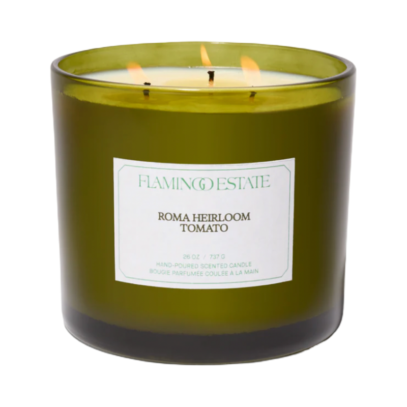 Green candle with a label on a white background