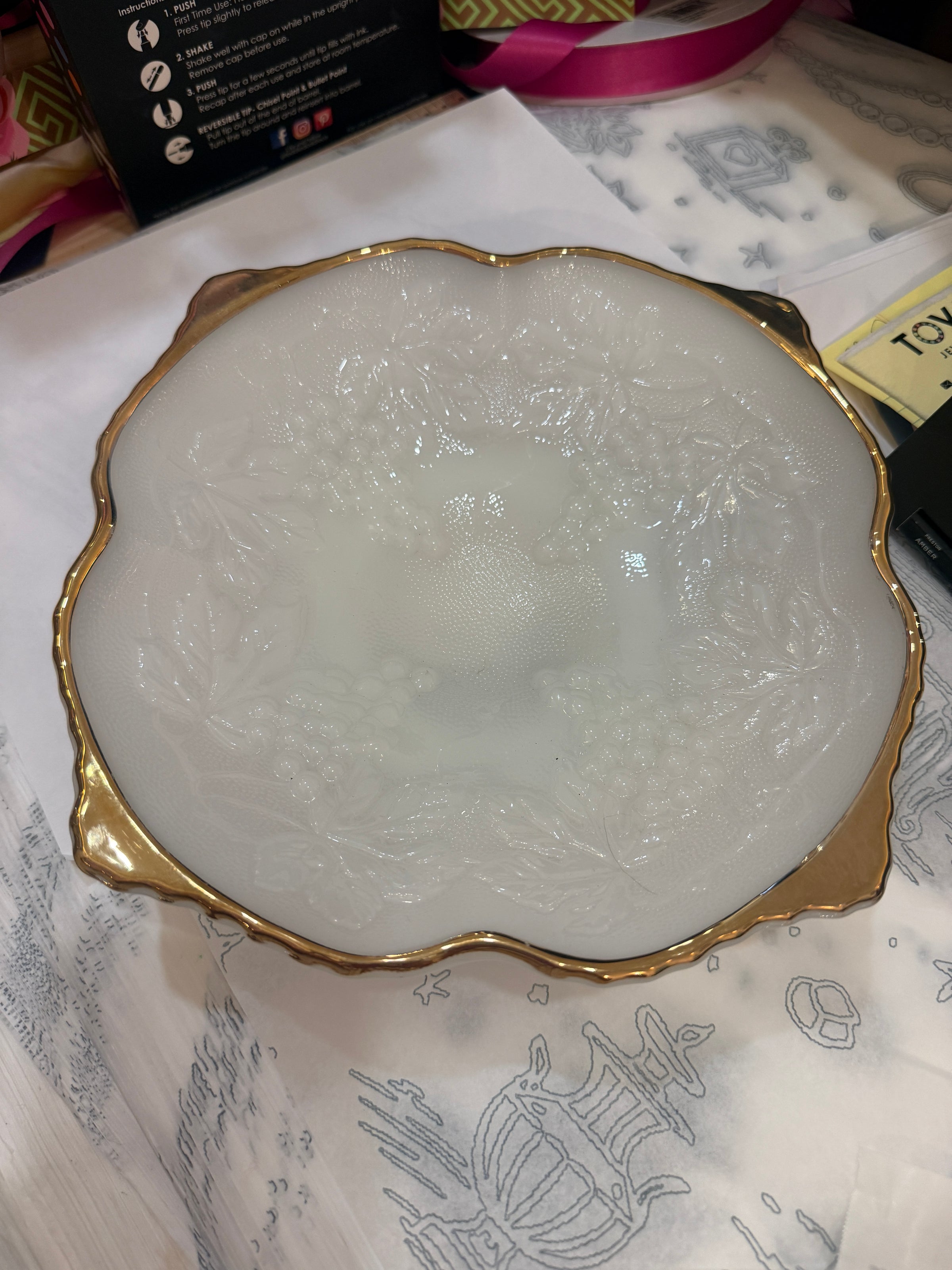 Decorative white stone with gold rim on a patterned surface