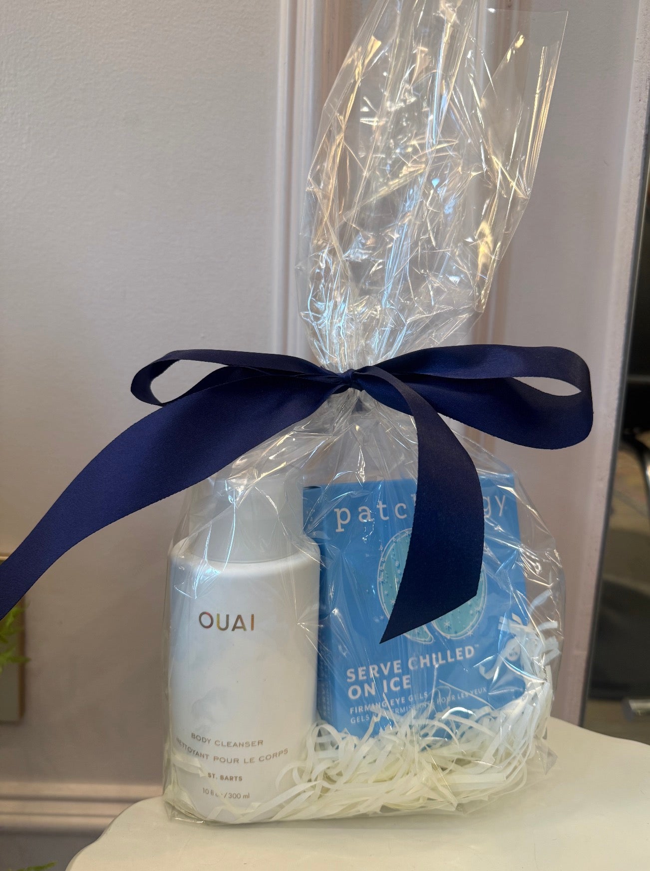 Gift set with OUAI hair product and Patchy packaging on a white surface.