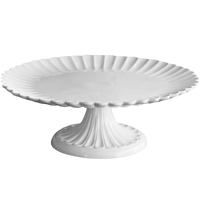 White decorative cake stand on a white background